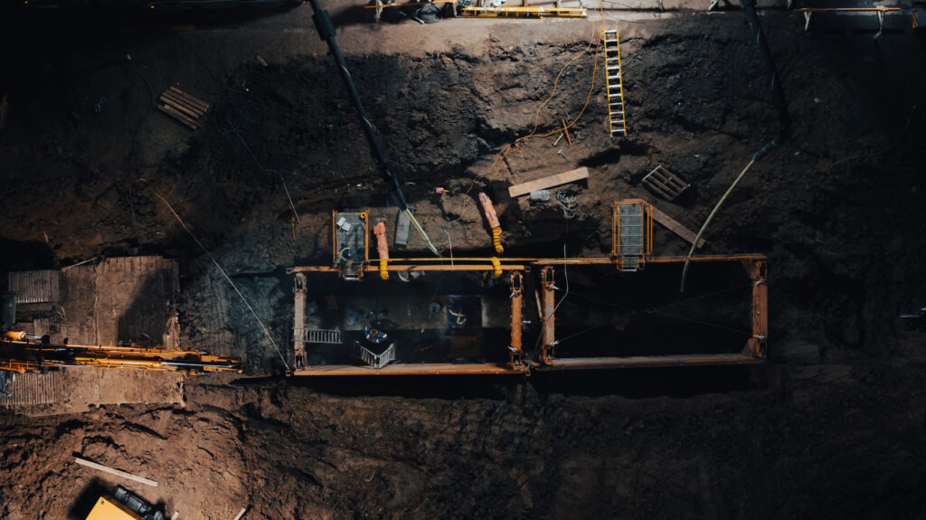 Shored excavation with exposed watermain during underground infrastructure repair
