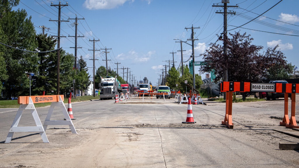 Road closure and traffic control setup along 92 Avenue during watermain construction