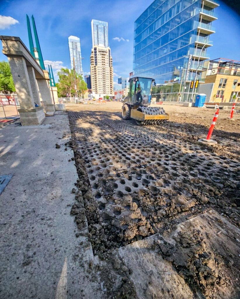Padfoot compactor operating on an underground infrastructure construction site in Edmonton
