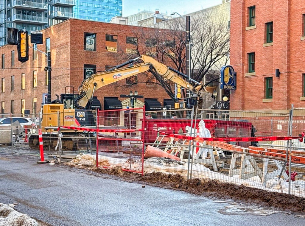 Barricaded and fenced GS Construction site in downtown Edmonton during active underground infrastructure work