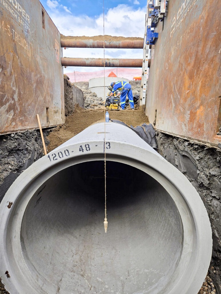 Plumb bob used to ensure precise vertical alignment of a reinforced concrete pipe during the Dome Substation LID Stormwater Storage project