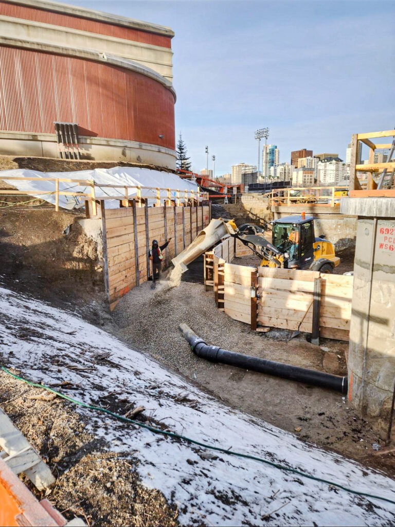 Storm sewer piping placed inside a lagging wall excavation with temporary earth support