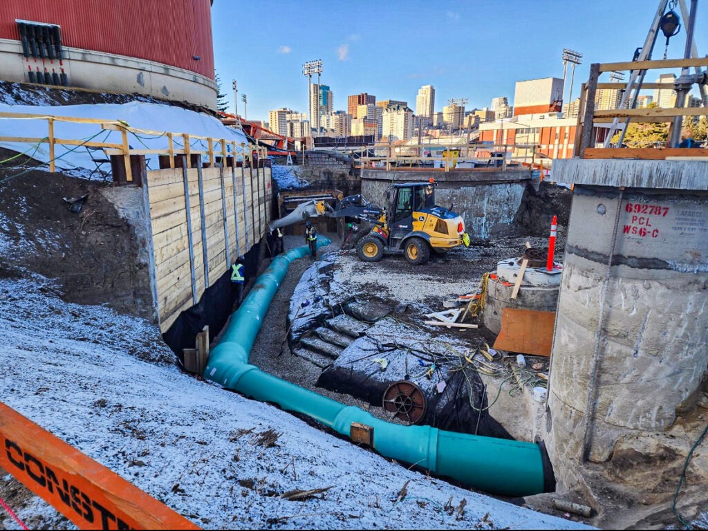 Storm piping installed within a lagging wall excavation during underground infrastructure work