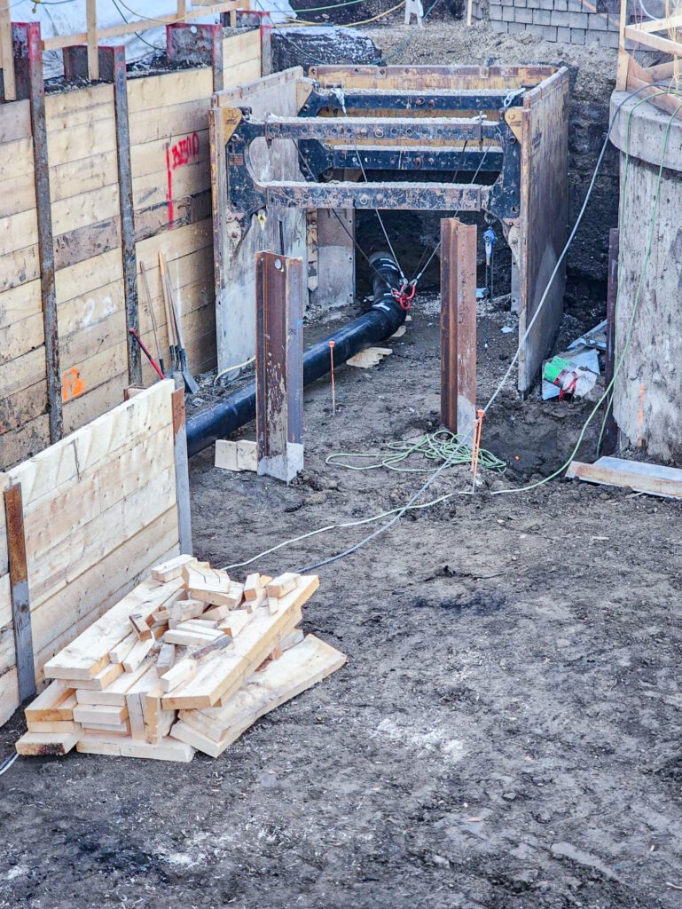 Installation of a trench box inside a lagging wall excavation for storm sewer construction