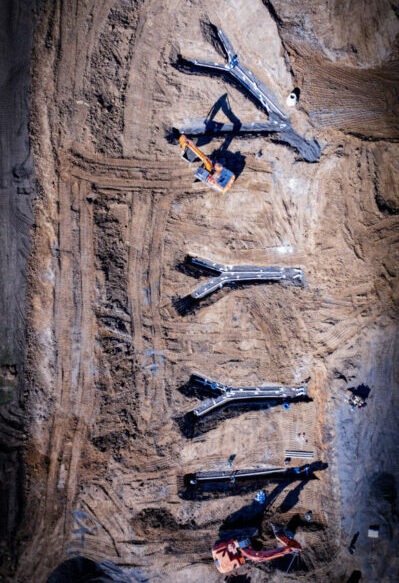 Aerial view of GS Construction installing water and wastewater infrastructure lines for new residential development using civil construction methods