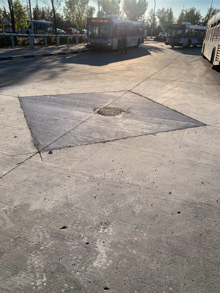 Completed SIRP manhole repair with final paving top coat restored around the manhole lid